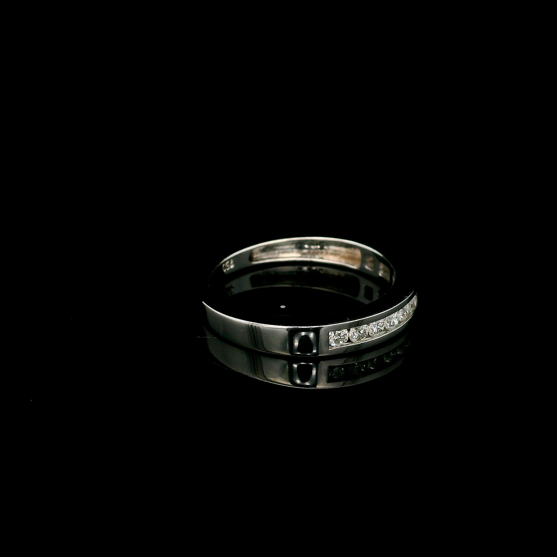 18K white gold channel set diamond wedding band featuring 0.36 carat natural round brilliant diamonds in a sleek polished stackable ring design.