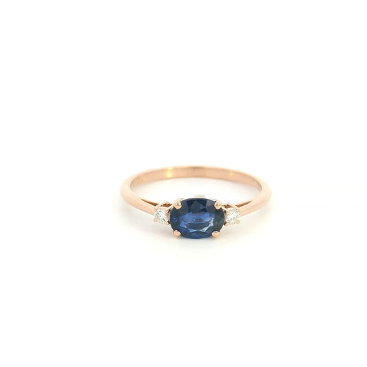 18K rose gold oval blue sapphire ring featuring a 1.06 Carat natural sapphire with round natural diamond side stones.