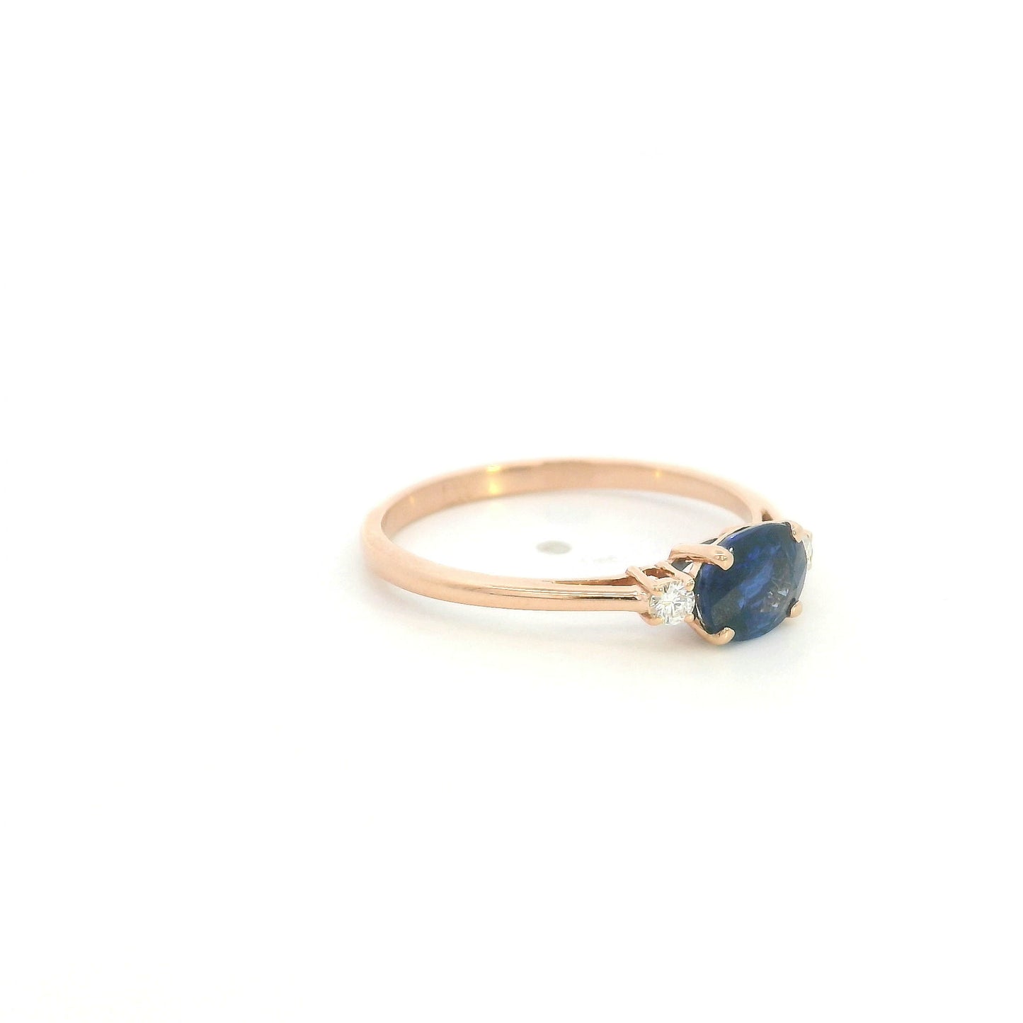 18K rose gold oval blue sapphire ring featuring a 1.06 Carat natural sapphire with round natural diamond side stones.