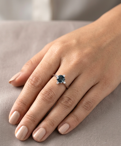 18K white gold London Blue Topaz ring featuring a 1.10 carat natural cushion-cut London Blue Topaz with 0.14 carat natural diamond accents.