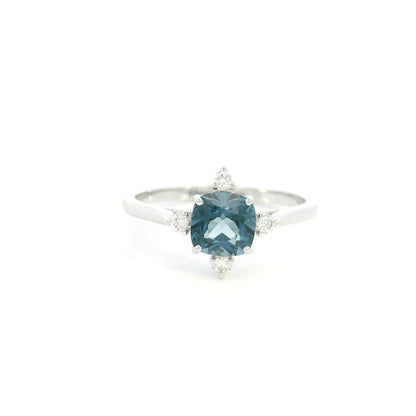 18K white gold London Blue Topaz ring featuring a 1.10 carat natural cushion-cut London Blue Topaz with 0.14 carat natural diamond accents.