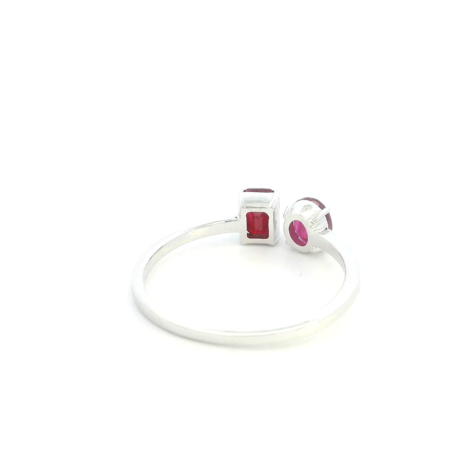 18K White Gold Natural Ruby Toi et Moi Ring featuring an oval and emerald-cut ruby in a modern open design.