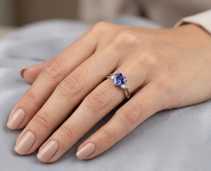 18K white gold heart tanzanite ring featuring a 1.29 carat heart-shaped natural tanzanite with 0.09 carat natural diamond accents.