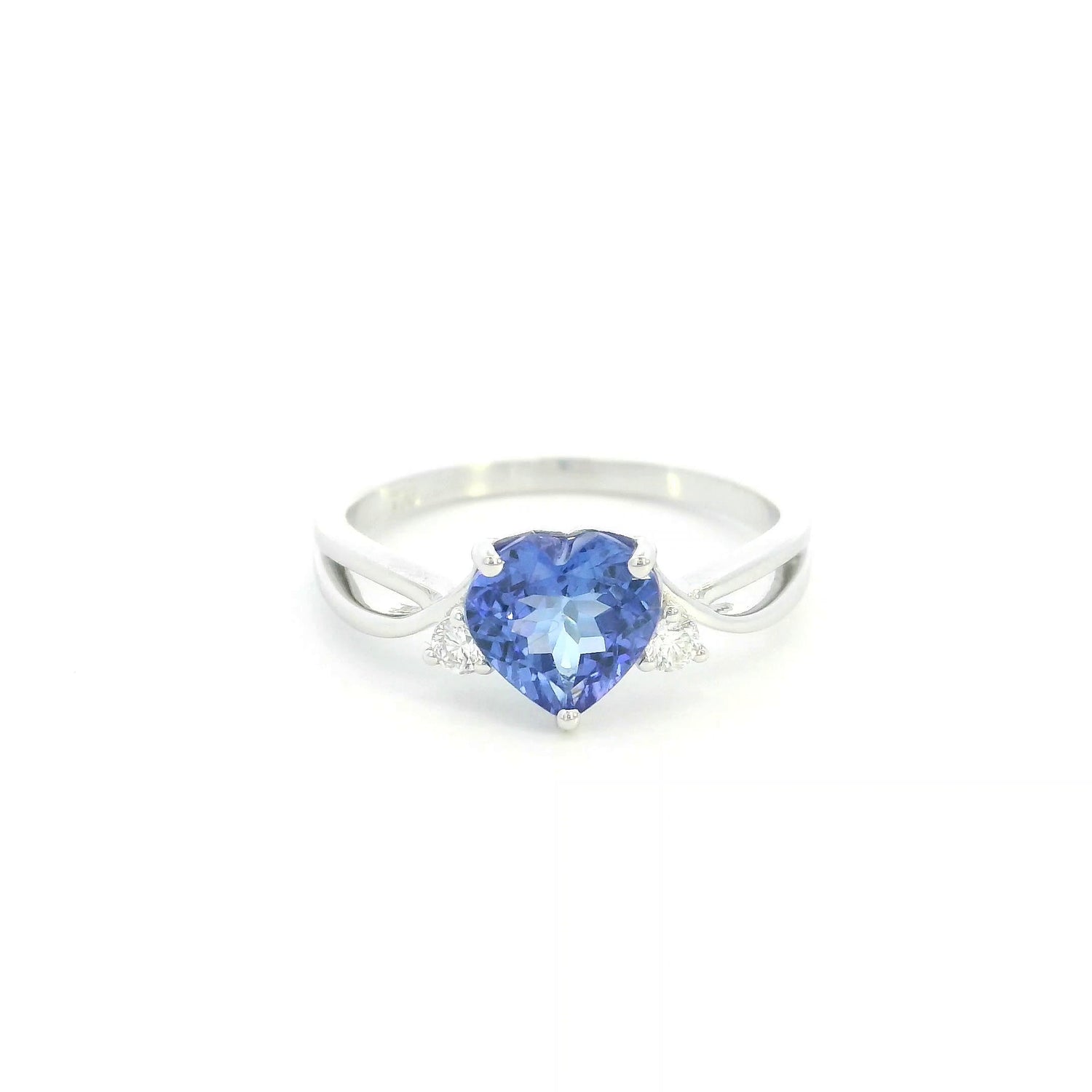 18K white gold heart tanzanite ring featuring a 1.29 carat heart-shaped natural tanzanite with 0.09 carat natural diamond accents.