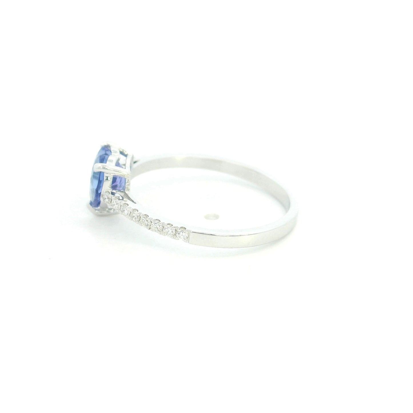 Heart Tanzanite Diamond Ring in 18K white gold featuring a natural 1.08 carat heart-cut tanzanite with a diamond-set band.