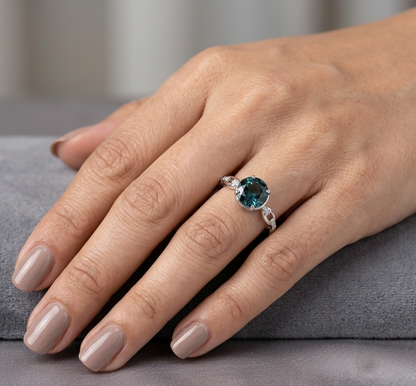 Round London Blue Topaz diamond ring in 18K white gold with sculpted open-detail band