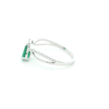 Pear shaped natural emerald and diamond ring in 18K white gold with diamond accented sculpted shoulders