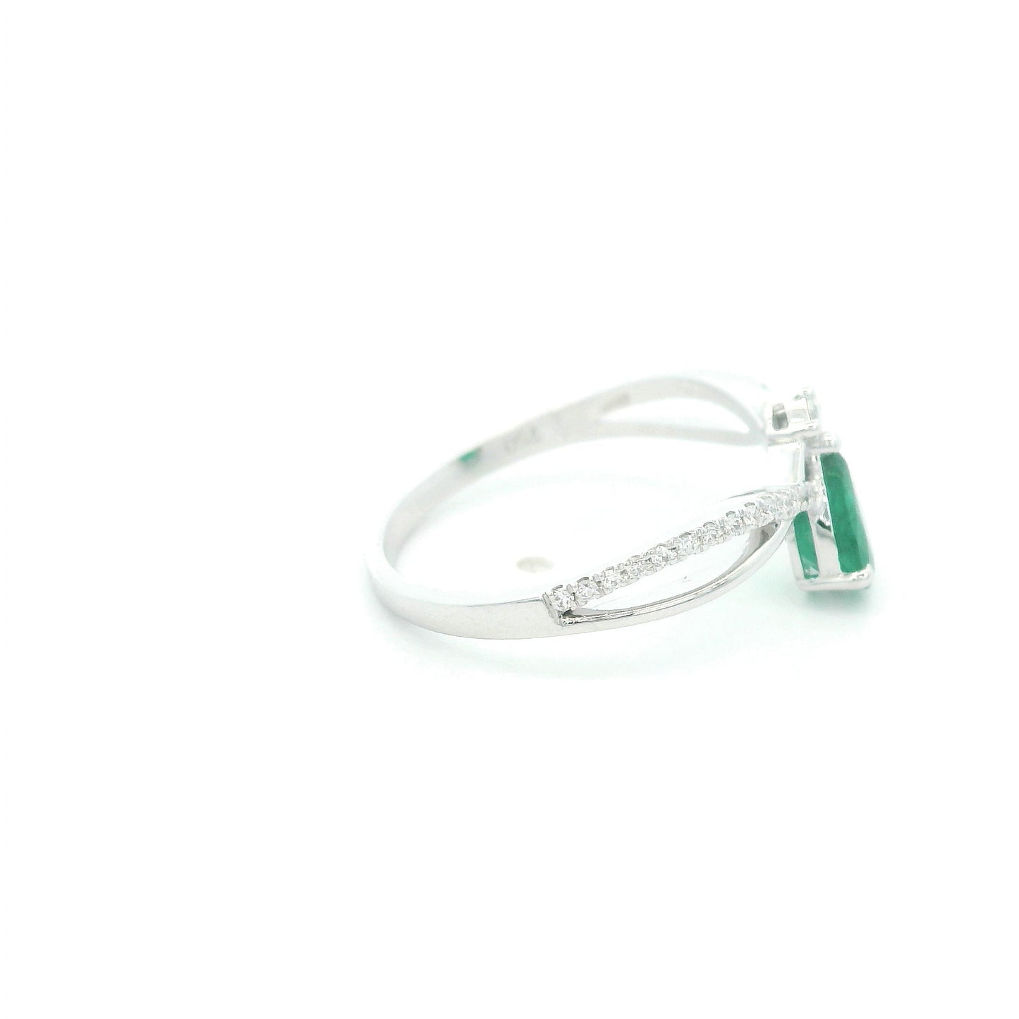 Pear shaped natural emerald and diamond ring in 18K white gold with diamond accented sculpted shoulders