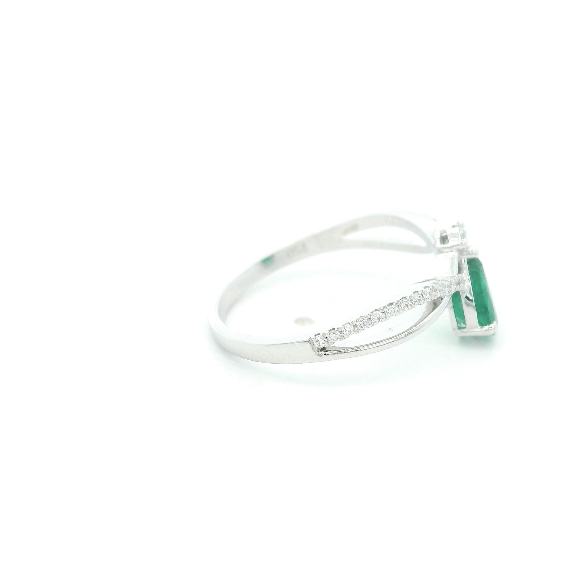 Pear shaped natural emerald and diamond ring in 18K white gold with diamond accented sculpted shoulders