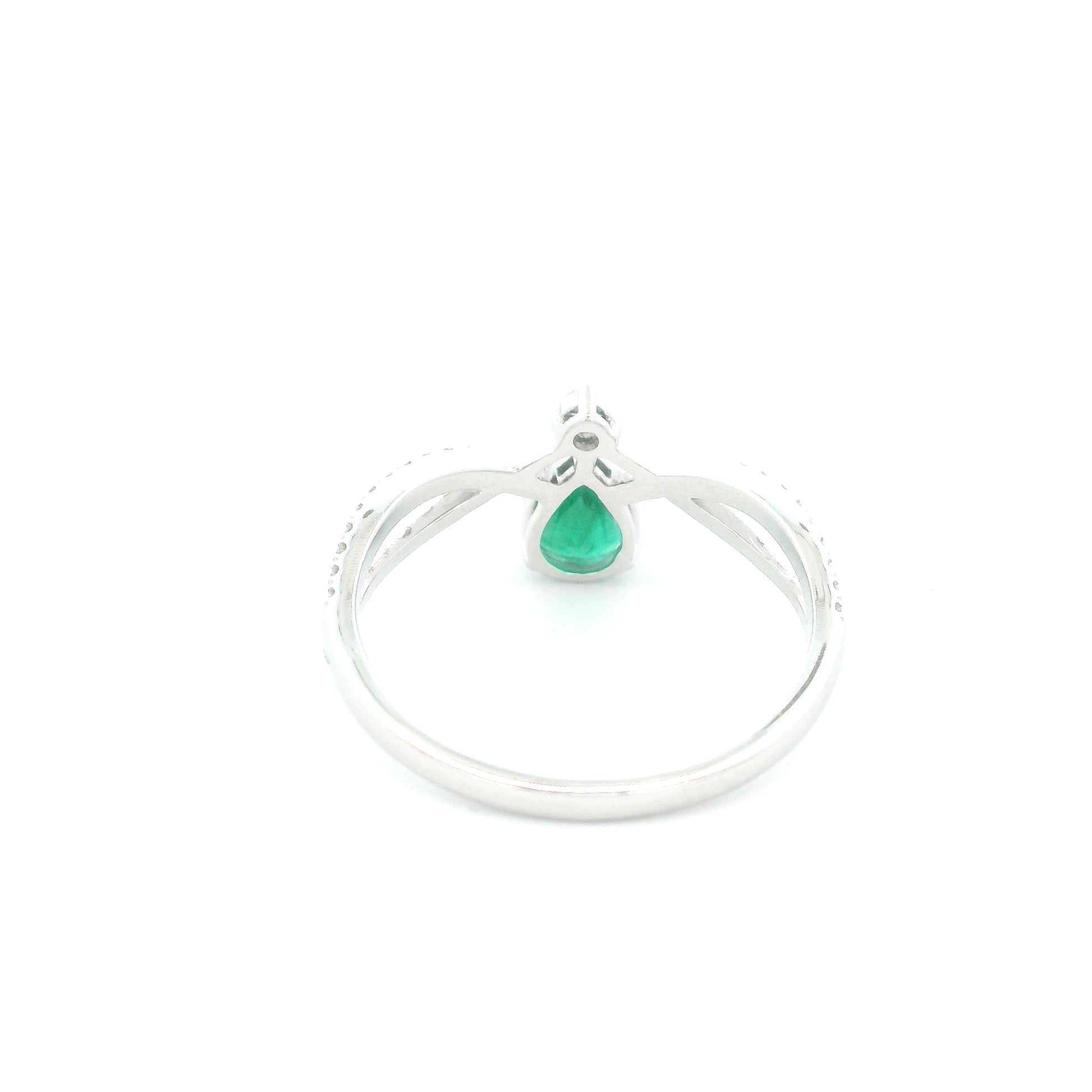 Pear shaped natural emerald and diamond ring in 18K white gold with diamond accented sculpted shoulders