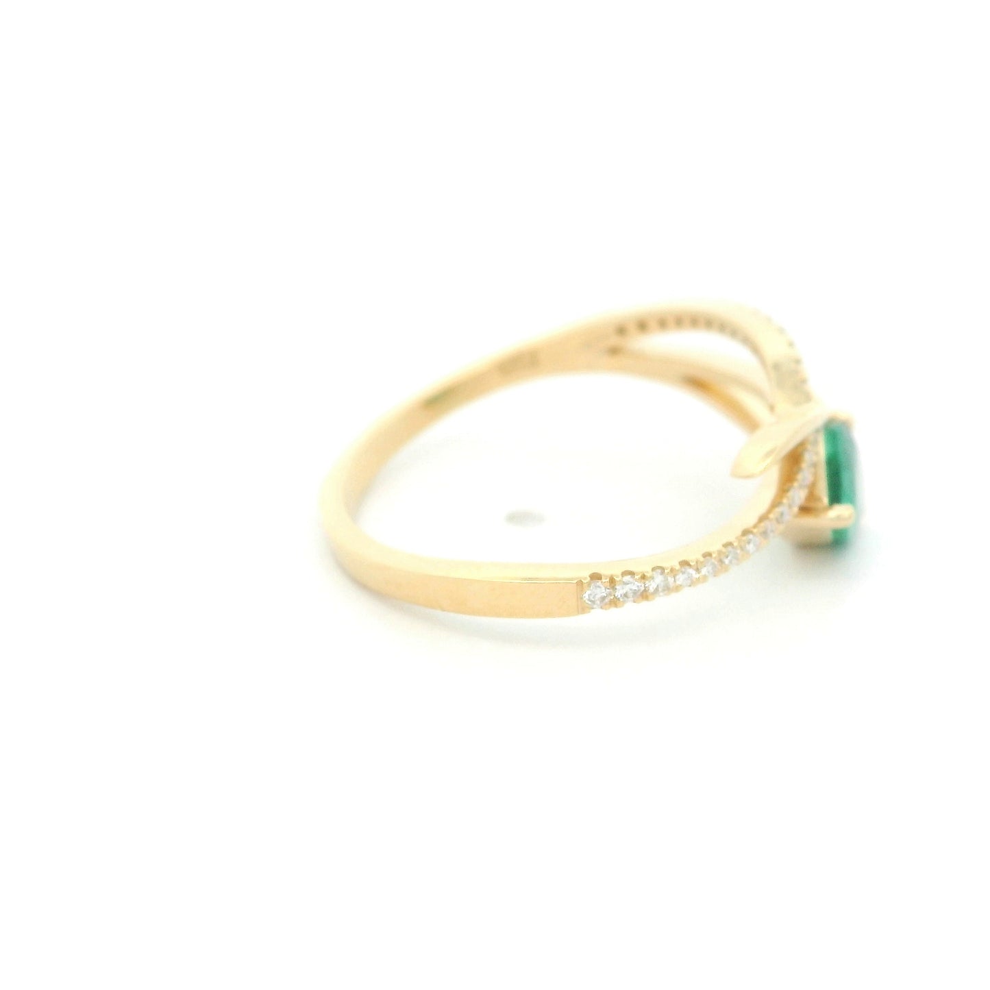 18K yellow gold emerald crossover ring featuring a 0.51 carat natural emerald and 0.09 carat natural diamond accent band.