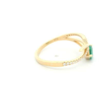 18K yellow gold emerald crossover ring featuring a 0.51 carat natural emerald and 0.09 carat natural diamond accent band.