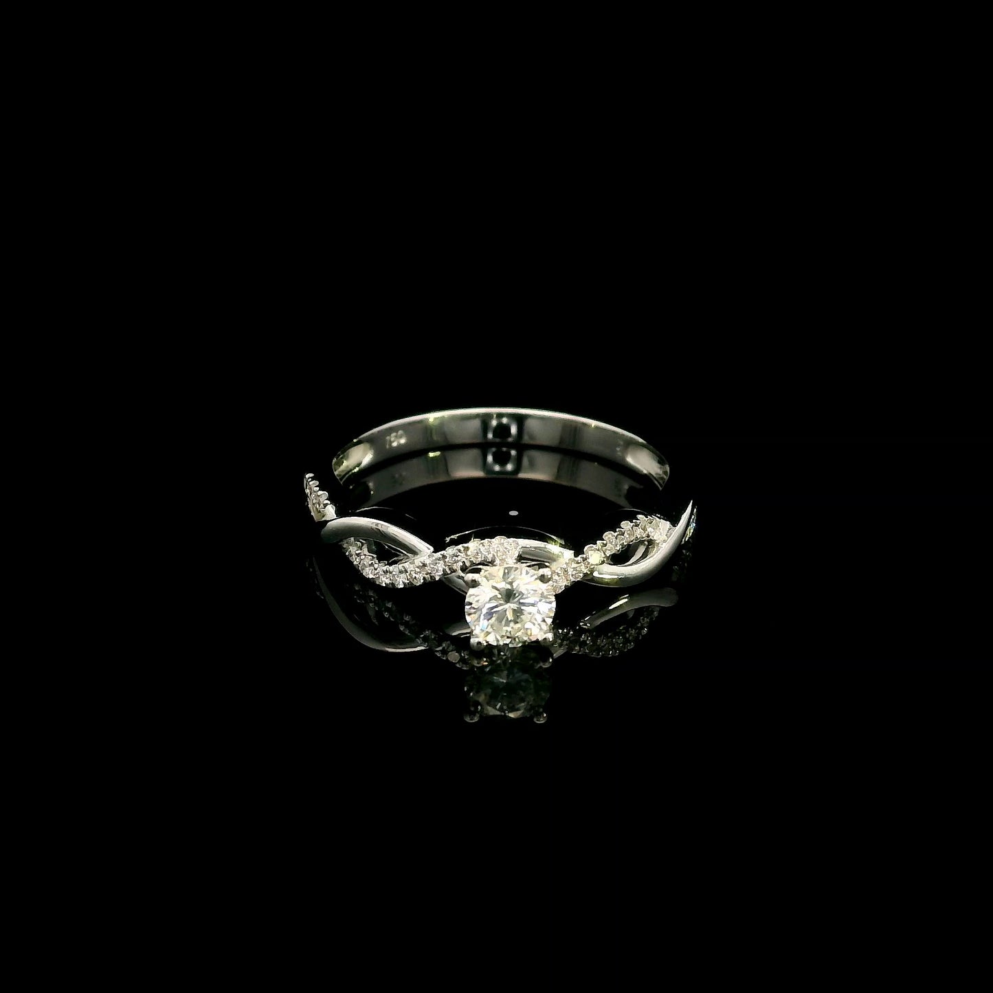 18K White Gold Diamond Engagement Ring with a 0.31 Carat Round Brilliant Diamond and 0.11 Carat Pavé Diamond Twisted Band.