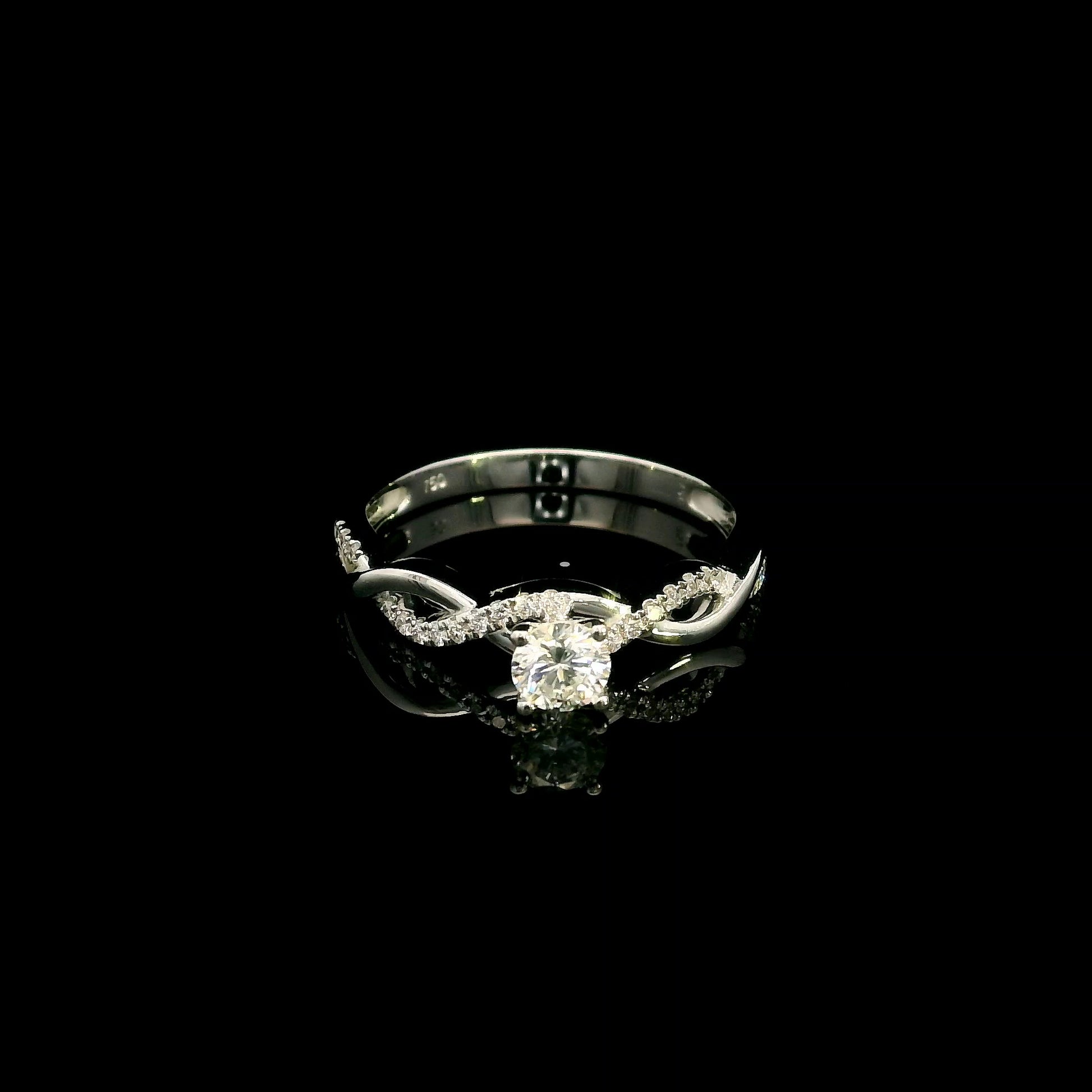 18K White Gold Diamond Engagement Ring with a 0.31 Carat Round Brilliant Diamond and 0.11 Carat Pavé Diamond Twisted Band.