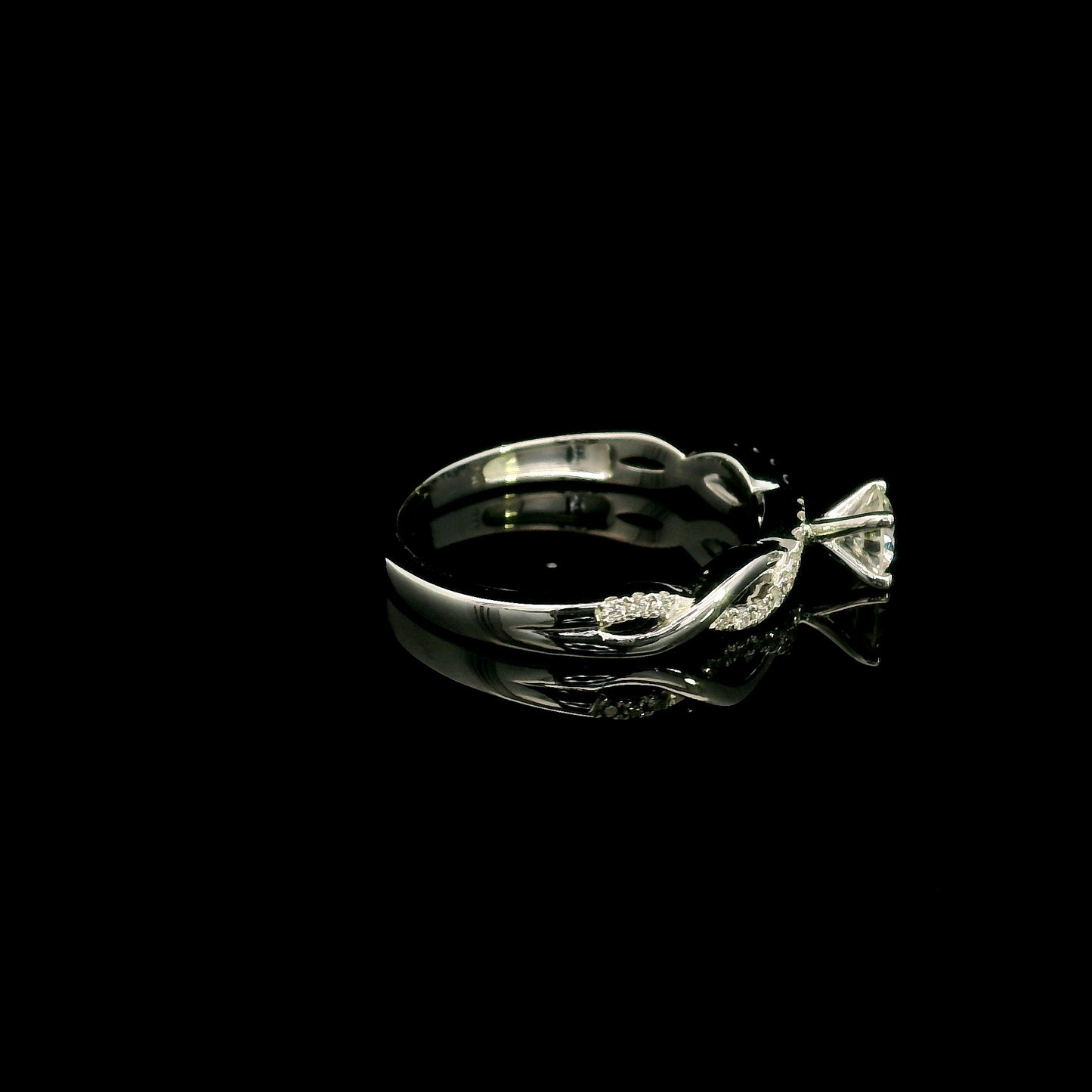 18K White Gold Diamond Engagement Ring with a 0.31 Carat Round Brilliant Diamond and 0.11 Carat Pavé Diamond Twisted Band.