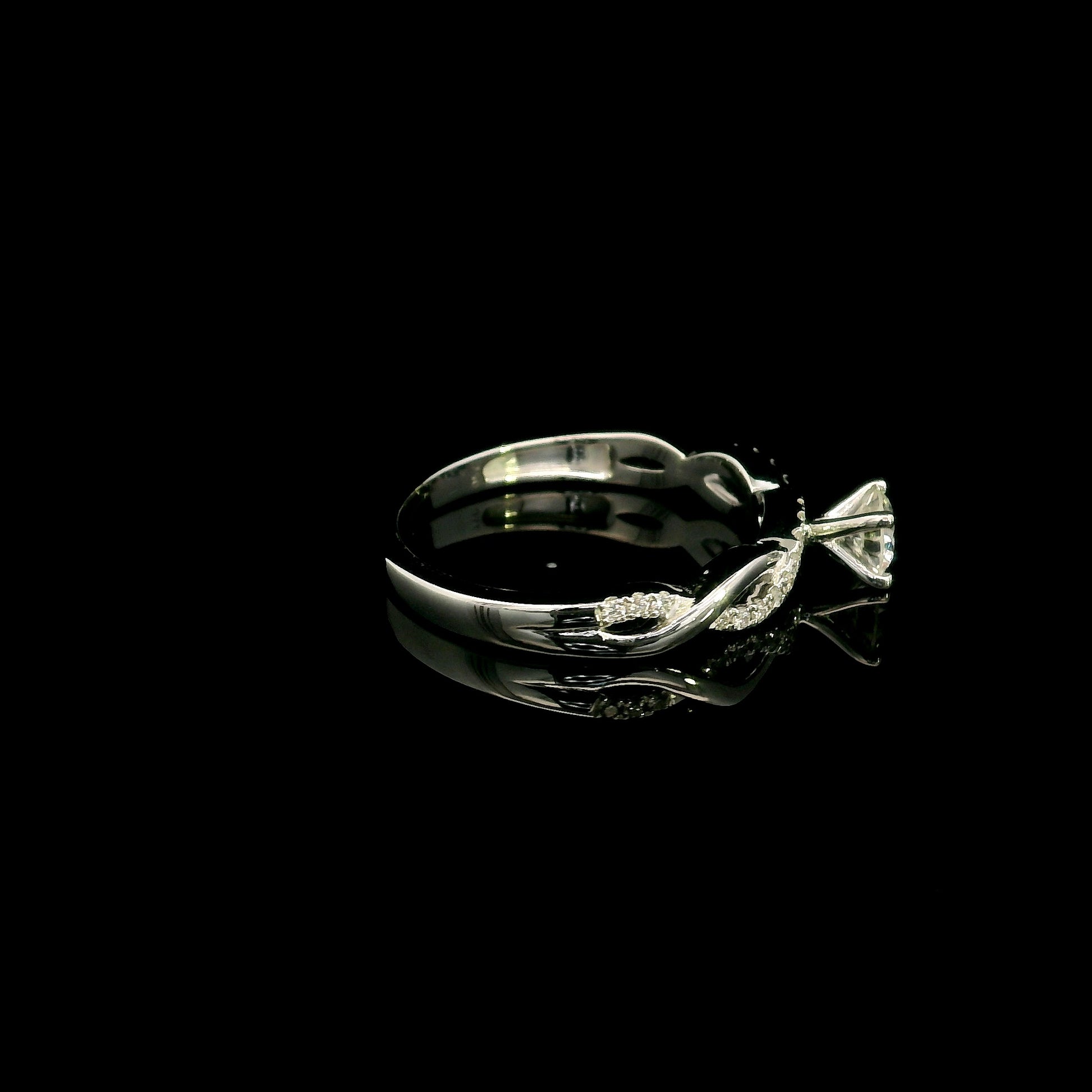 18K White Gold Diamond Engagement Ring with a 0.31 Carat Round Brilliant Diamond and 0.11 Carat Pavé Diamond Twisted Band.