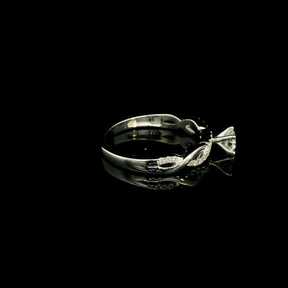 18K White Gold Diamond Engagement Ring with a 0.31 Carat Round Brilliant Diamond and 0.11 Carat Pavé Diamond Twisted Band.