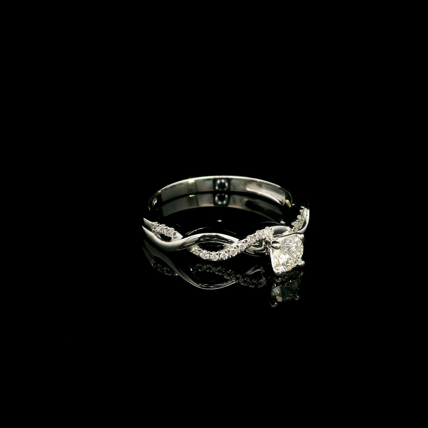 18K White Gold Diamond Engagement Ring with a 0.31 Carat Round Brilliant Diamond and 0.11 Carat Pavé Diamond Twisted Band.