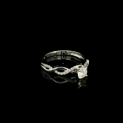18K White Gold Diamond Engagement Ring with a 0.31 Carat Round Brilliant Diamond and 0.11 Carat Pavé Diamond Twisted Band.
