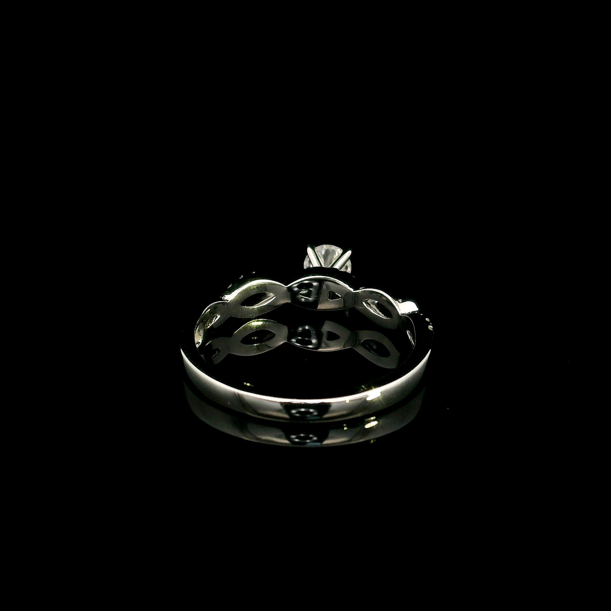 18K White Gold Diamond Engagement Ring with a 0.31 Carat Round Brilliant Diamond and 0.11 Carat Pavé Diamond Twisted Band.