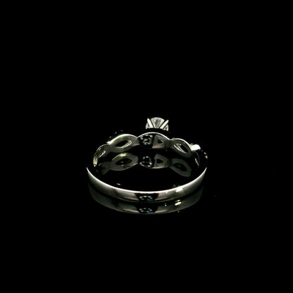 18K White Gold Diamond Engagement Ring with a 0.31 Carat Round Brilliant Diamond and 0.11 Carat Pavé Diamond Twisted Band.
