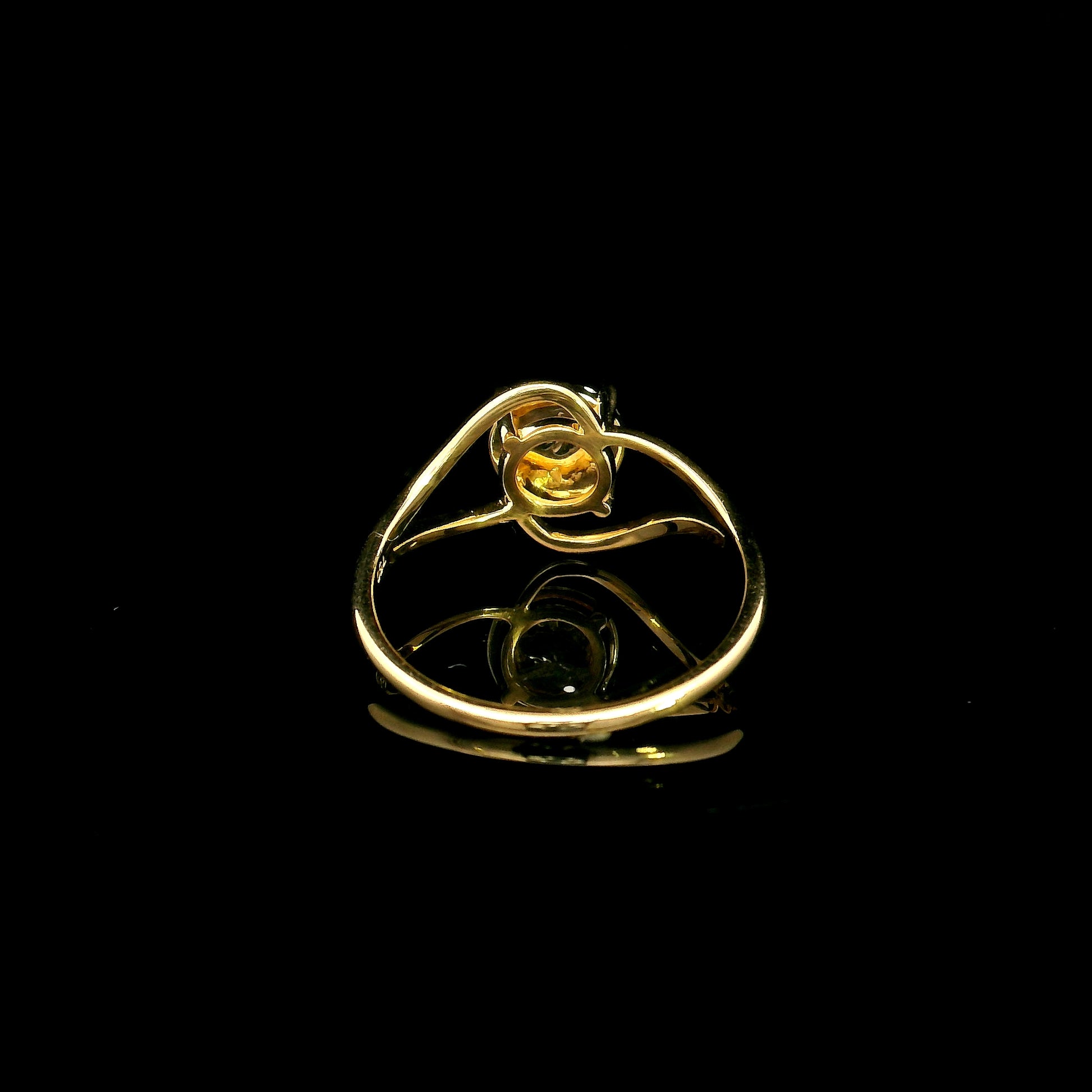 18K yellow gold diamond cluster ring with round diamonds and flowing sculptural swirl design by Emirates Diamonds.