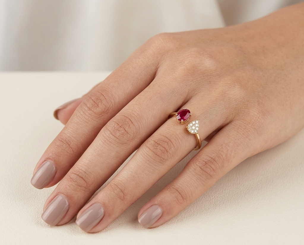 Oval ruby and diamond open ring in 18K yellow gold with pear shaped diamond cluster