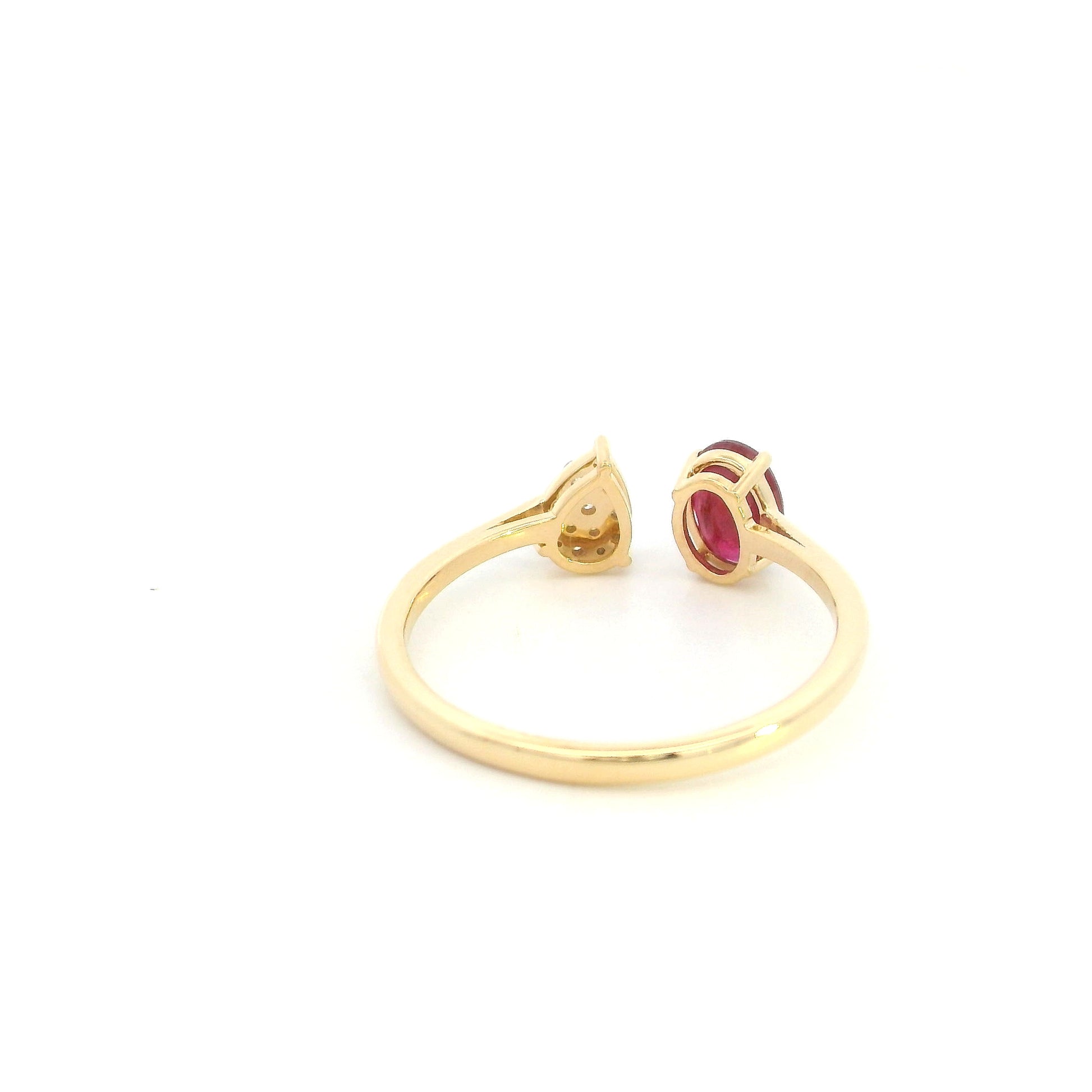 Oval ruby and diamond open ring in 18K yellow gold with pear shaped diamond cluster