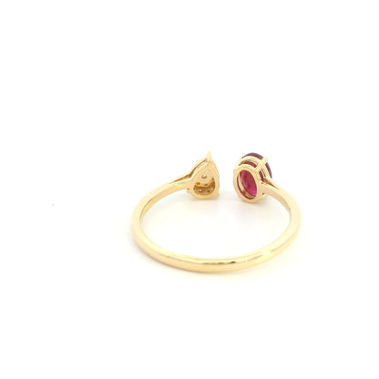 Oval ruby and diamond open ring in 18K yellow gold with pear shaped diamond cluster