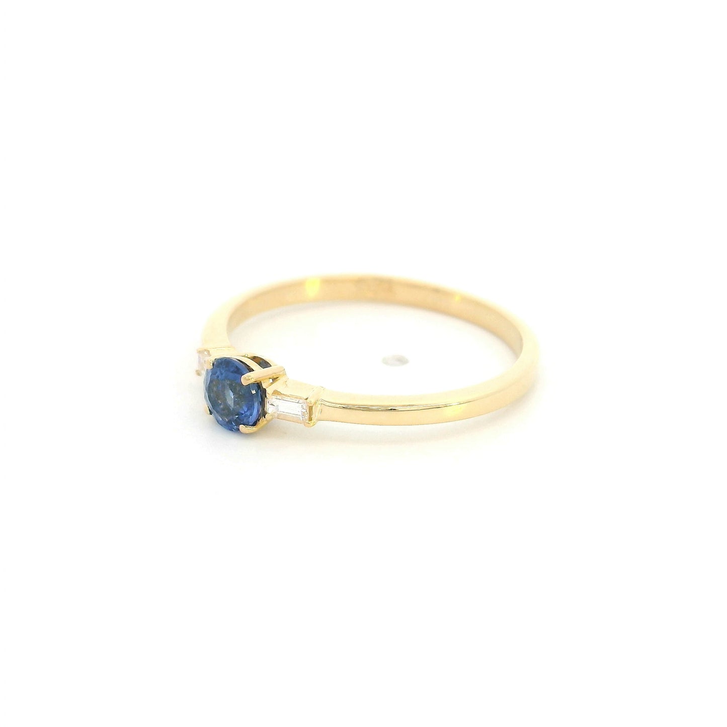 Round blue sapphire and baguette diamond three stone ring in 18K yellow gold