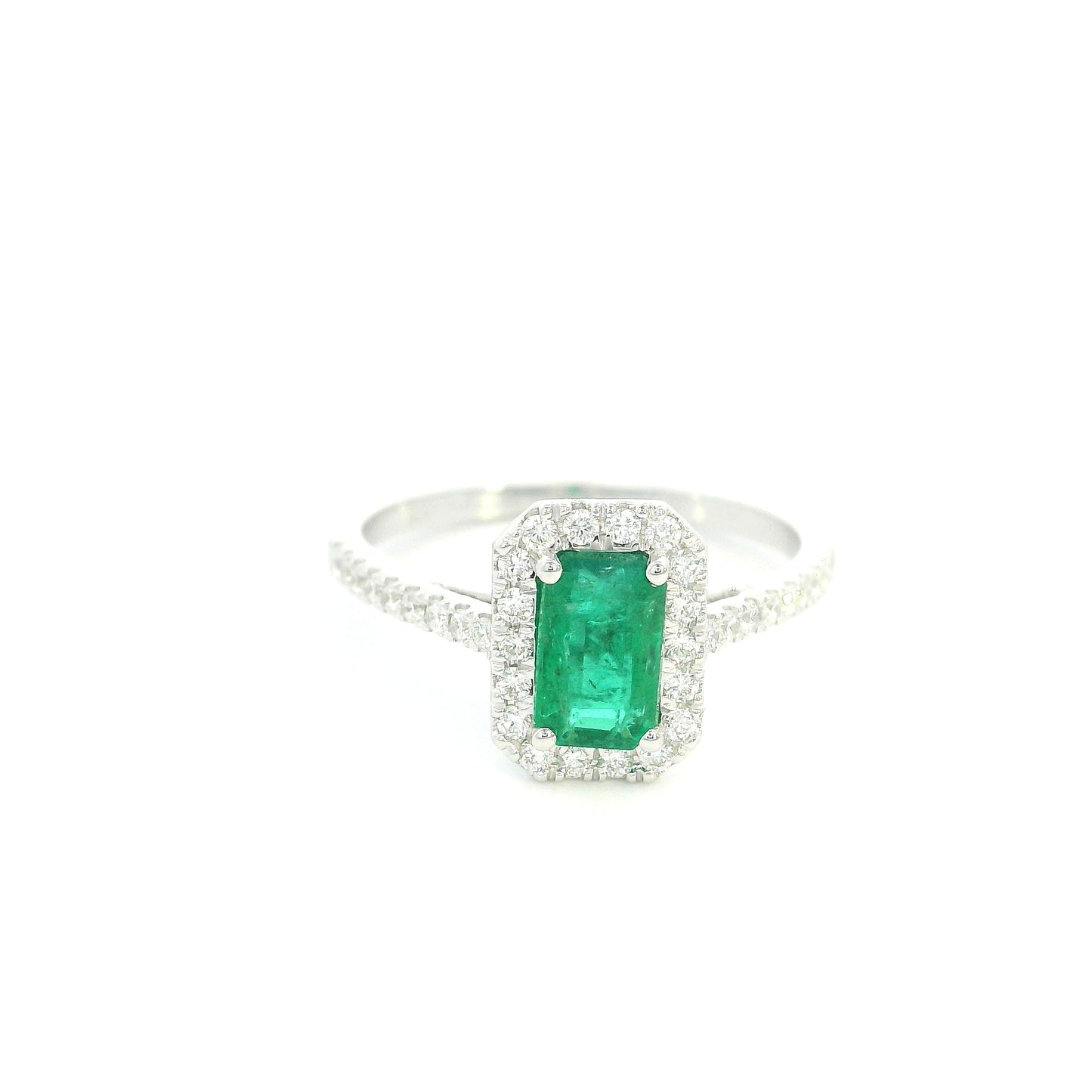 18K white gold emerald bridal set featuring a 0.71 carat natural emerald-cut emerald with a diamond halo and matching diamond wedding band.