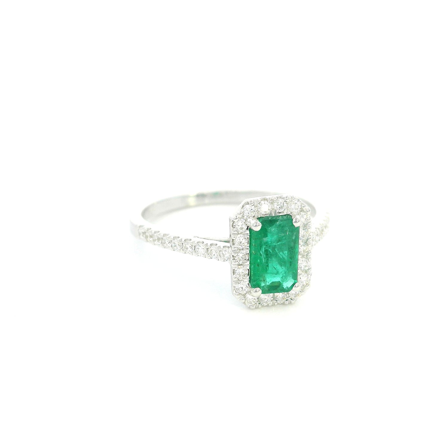 18K white gold emerald bridal set featuring a 0.71 carat natural emerald-cut emerald with a diamond halo and matching diamond wedding band.