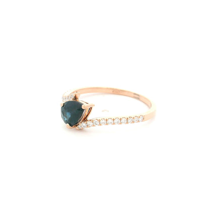 Natural pear-shaped blue sapphire ring in 18K rose gold featuring a 0.78 carat blue sapphire with a bypass diamond band set with 0.19 carat natural diamonds.