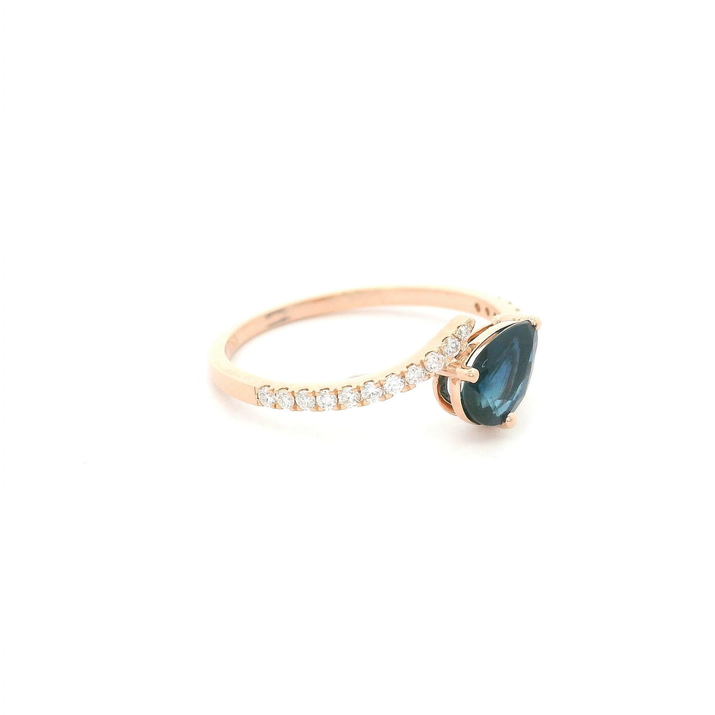 Natural pear-shaped blue sapphire ring in 18K rose gold featuring a 0.78 carat blue sapphire with a bypass diamond band set with 0.19 carat natural diamonds.