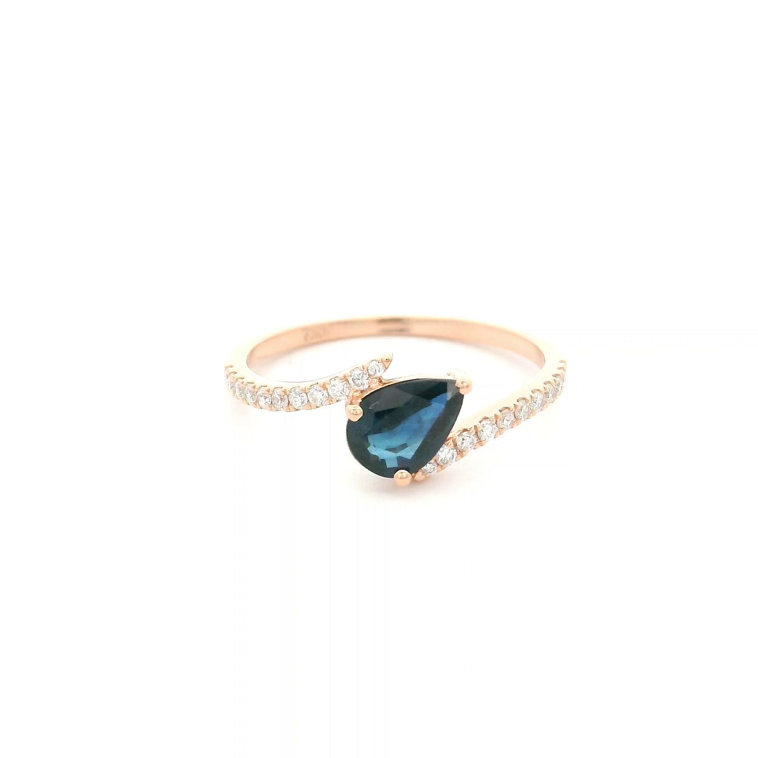 Natural pear-shaped blue sapphire ring in 18K rose gold featuring a 0.78 carat blue sapphire with a bypass diamond band set with 0.19 carat natural diamonds.