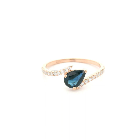 Natural pear-shaped blue sapphire ring in 18K rose gold featuring a 0.78 carat blue sapphire with a bypass diamond band set with 0.19 carat natural diamonds.