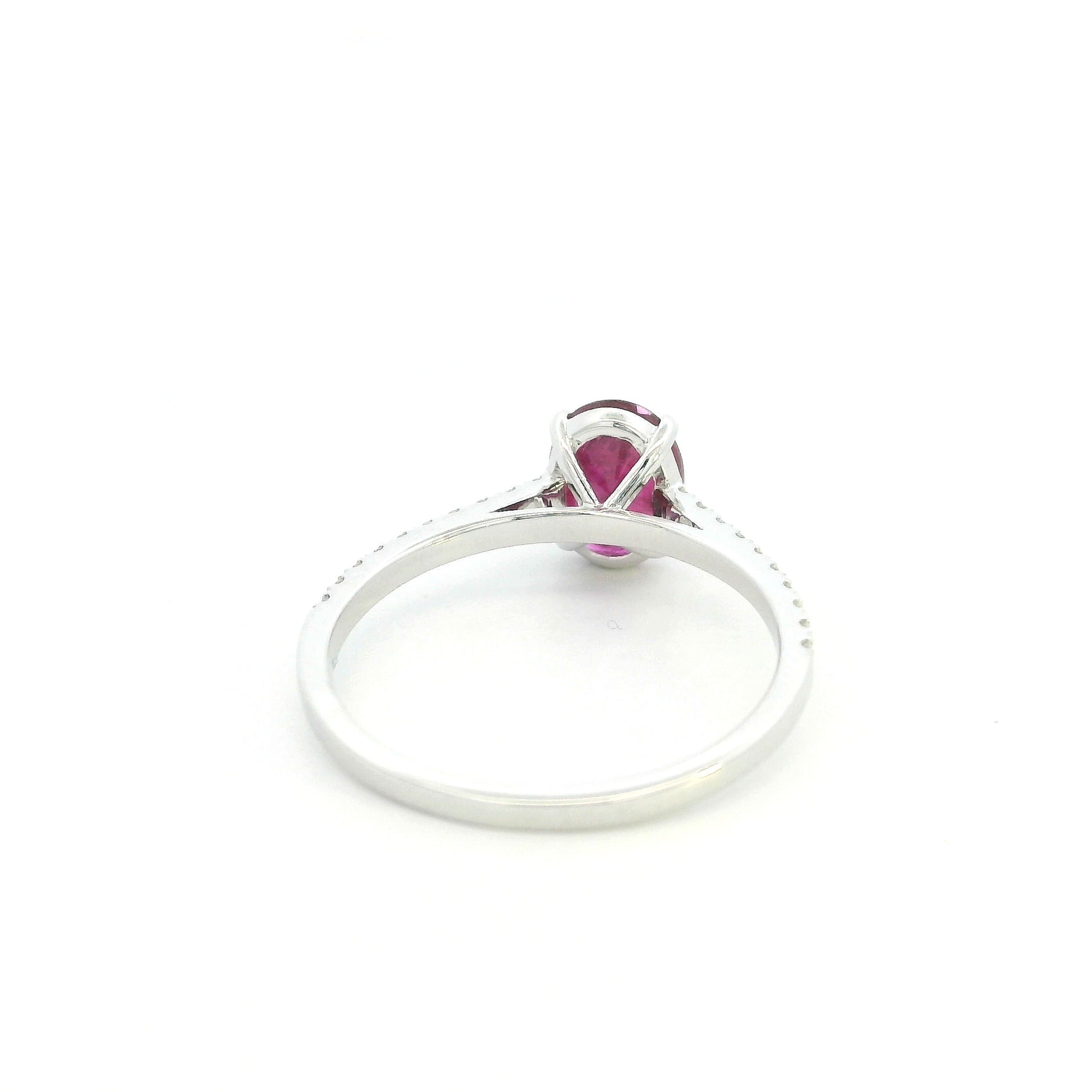 Ruby diamond ring in 18K white gold featuring a natural 1.32 carat oval-cut ruby with a diamond-set band.