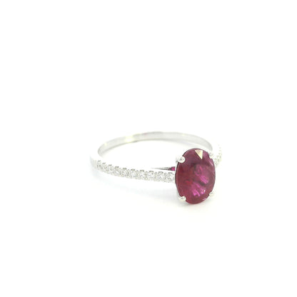 Ruby diamond ring in 18K white gold featuring a natural 1.32 carat oval-cut ruby with a diamond-set band.