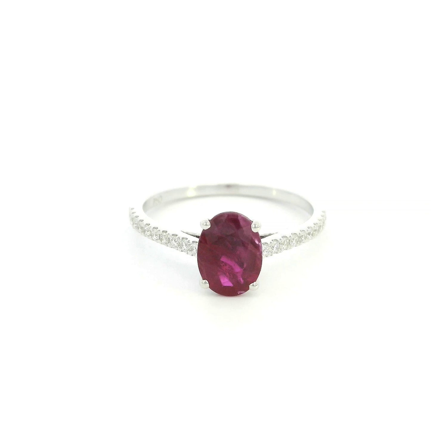 Ruby diamond ring in 18K white gold featuring a natural 1.32 carat oval-cut ruby with a diamond-set band.