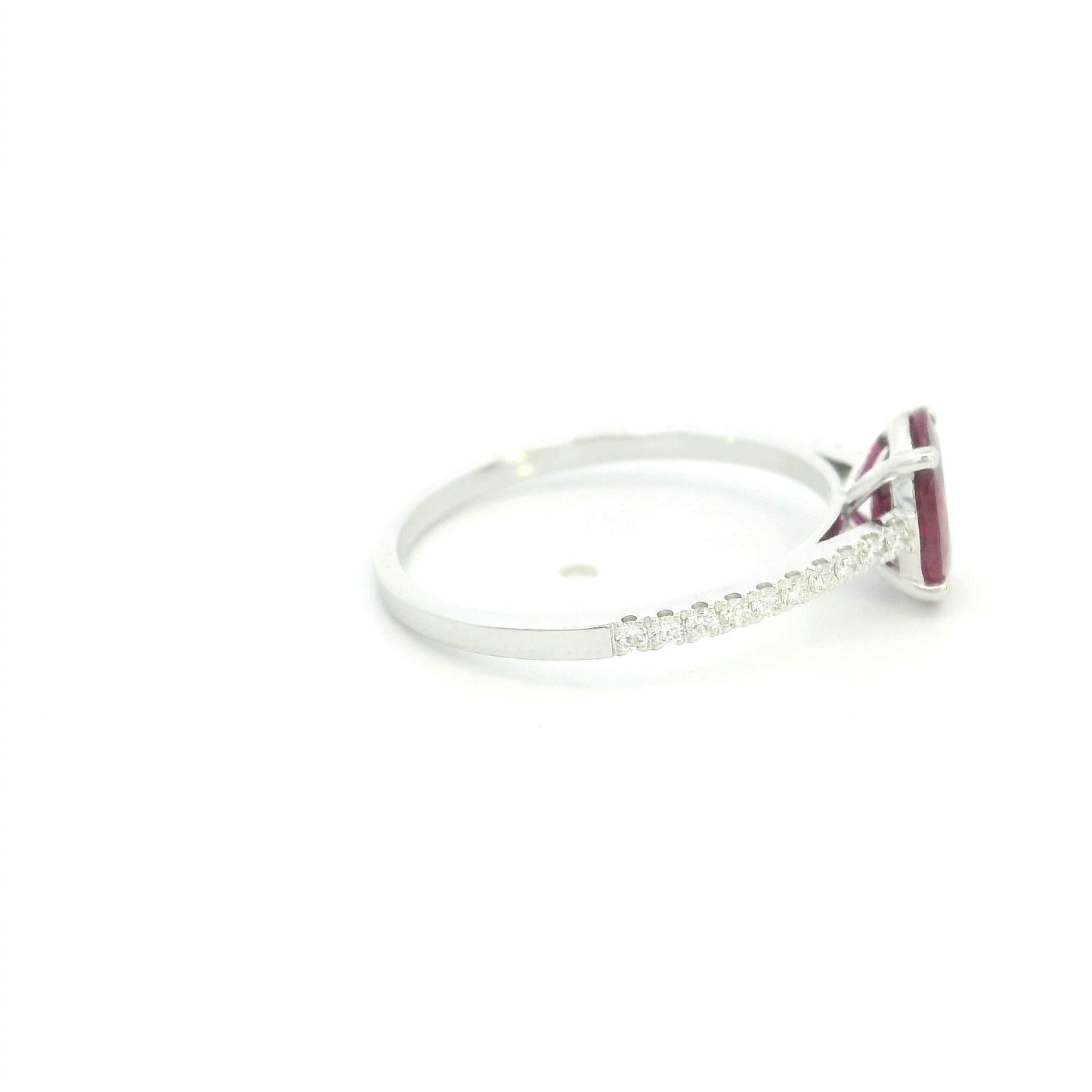Ruby diamond ring in 18K white gold featuring a natural 1.32 carat oval-cut ruby with a diamond-set band.