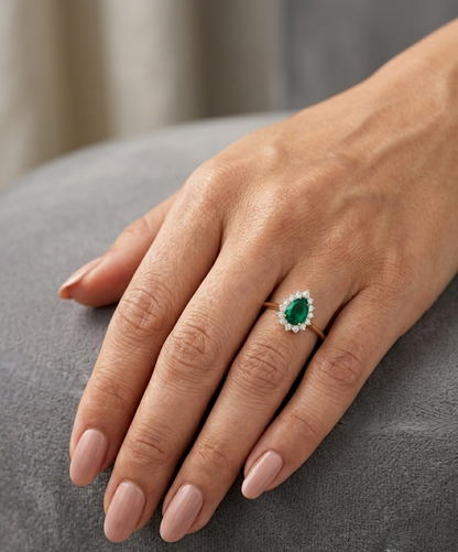 Pear shaped natural emerald diamond halo ring in 18K yellow gold