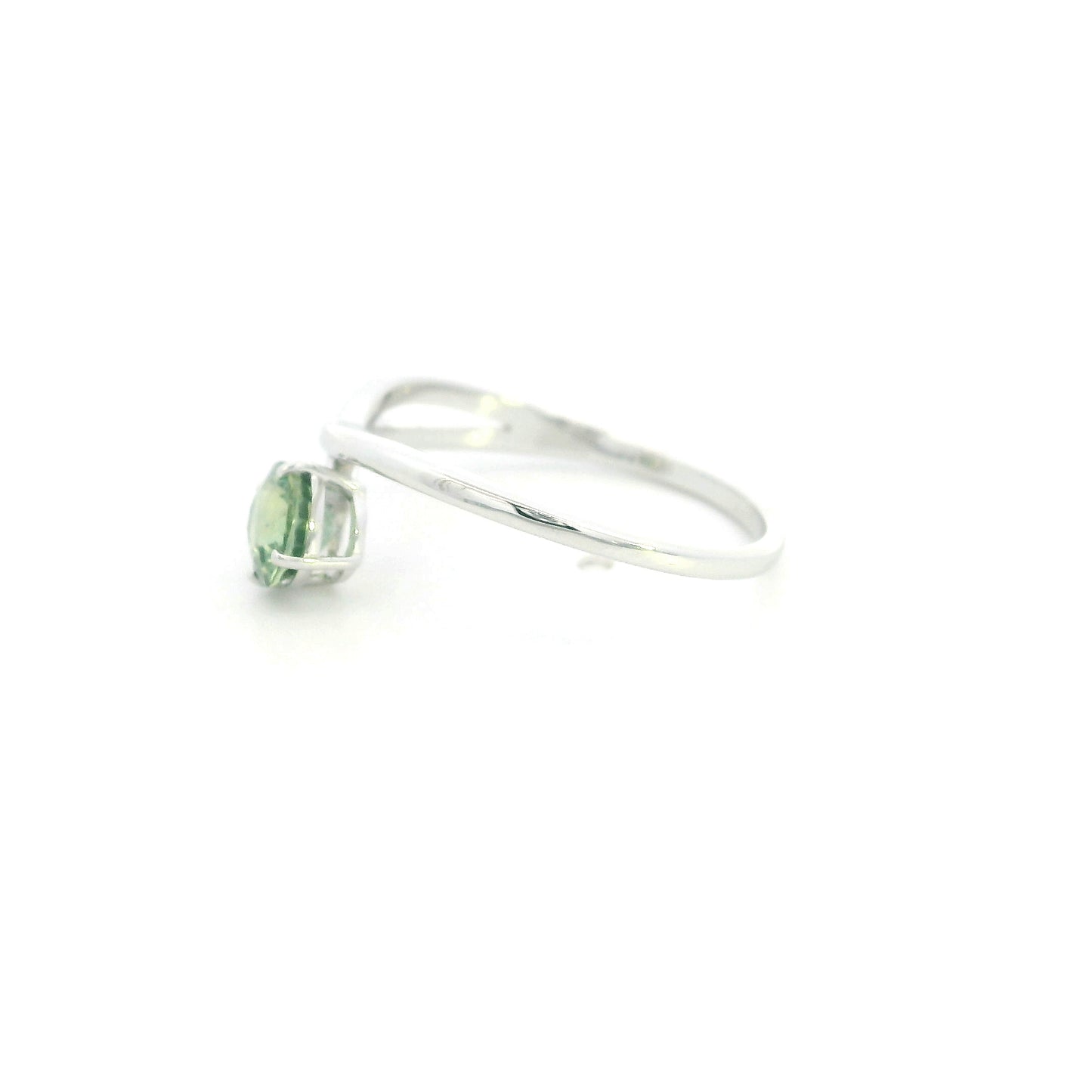 18K white gold crossover ring featuring a natural 0.88 carat round green sapphire in a contemporary solitaire design.