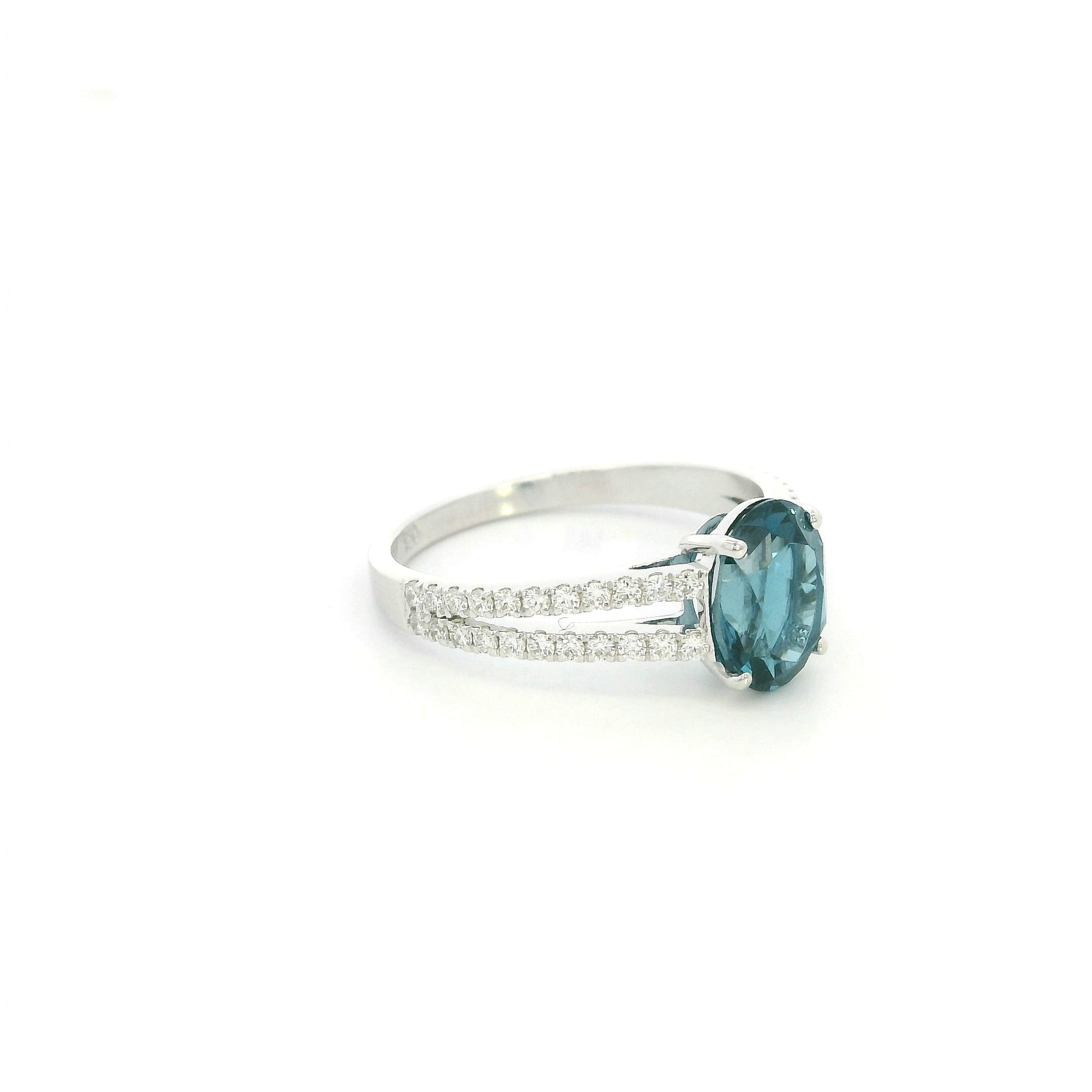 Natural London Blue Topaz ring in 18K white gold featuring a 2.22 carat oval London Blue Topaz with a split shank and 0.36 carat natural diamond band.