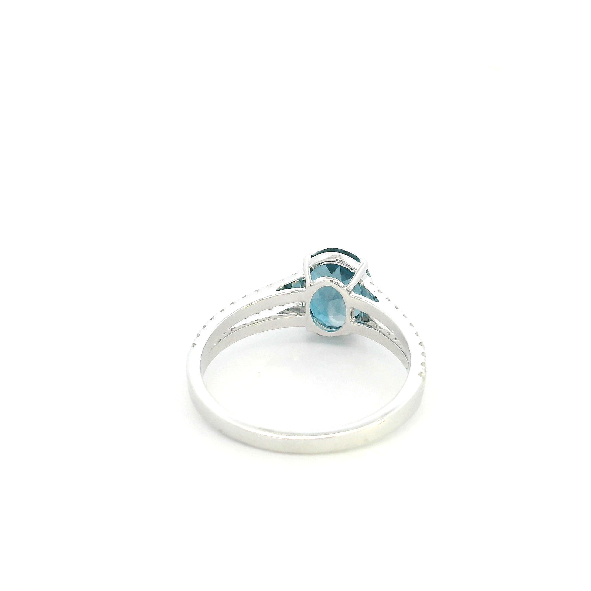 Natural London Blue Topaz ring in 18K white gold featuring a 2.22 carat oval London Blue Topaz with a split shank and 0.36 carat natural diamond band.