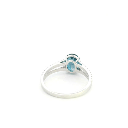 Natural London Blue Topaz ring in 18K white gold featuring a 2.22 carat oval London Blue Topaz with a split shank and 0.36 carat natural diamond band.