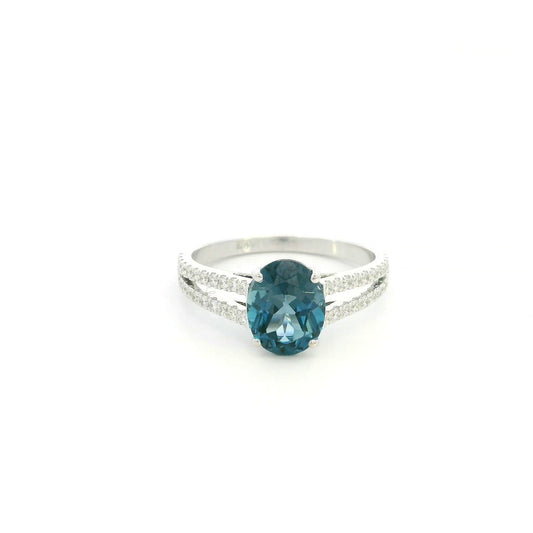 Natural London Blue Topaz ring in 18K white gold featuring a 2.22 carat oval London Blue Topaz with a split shank and 0.36 carat natural diamond band.
