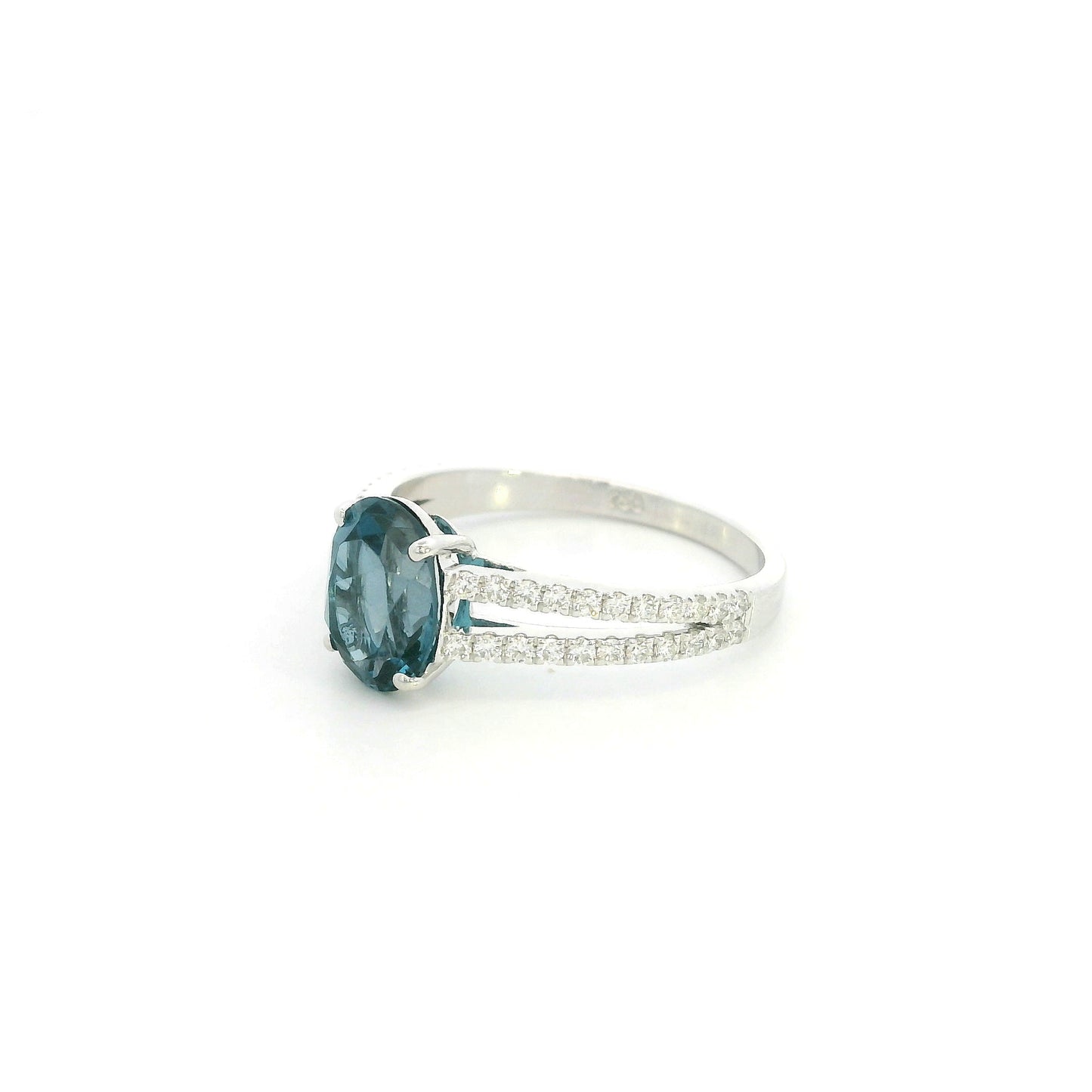 Natural London Blue Topaz ring in 18K white gold featuring a 2.22 carat oval London Blue Topaz with a split shank and 0.36 carat natural diamond band.