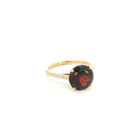 Garnet diamond ring in 18K yellow gold featuring a natural 4.59 carat round-cut garnet with a diamond-set band.