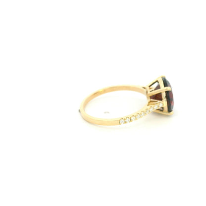 Garnet diamond ring in 18K yellow gold featuring a natural 4.59 carat round-cut garnet with a diamond-set band.