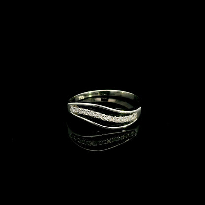 18K white gold diamond wave ring with a curved row of round diamonds and flowing polished gold design